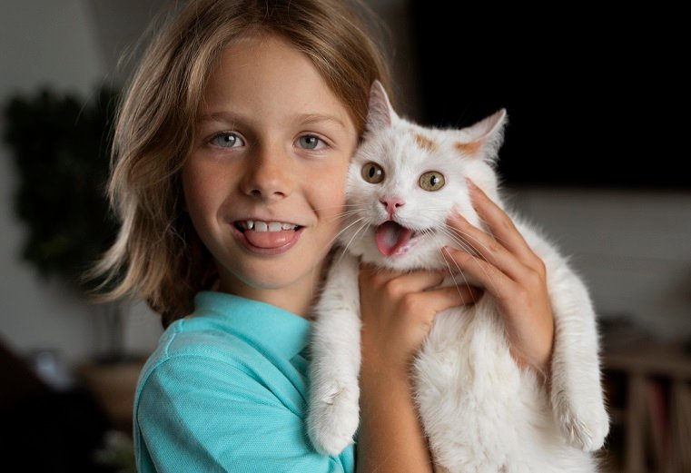 kid holding cat
